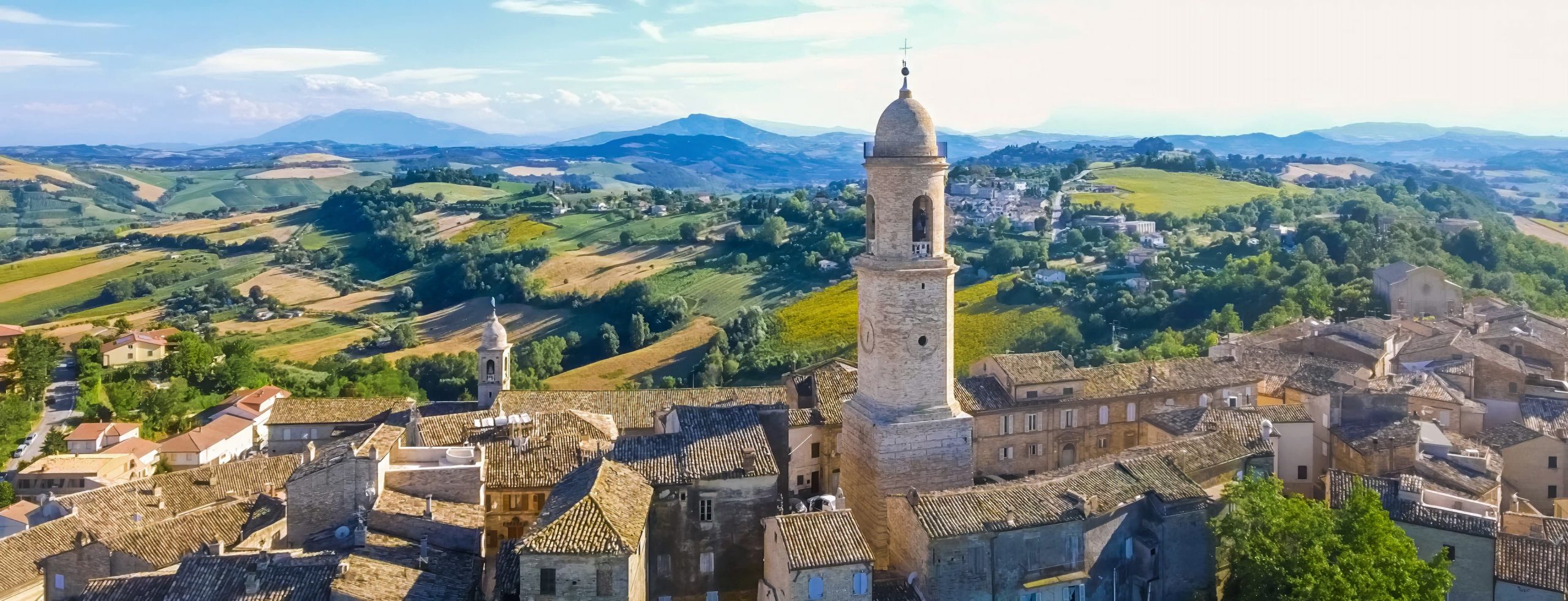 View over the rooftops and bell tower of Petritoli towards the Sibillini mountains
